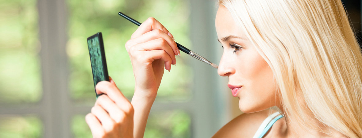 Woman applying cosmetics